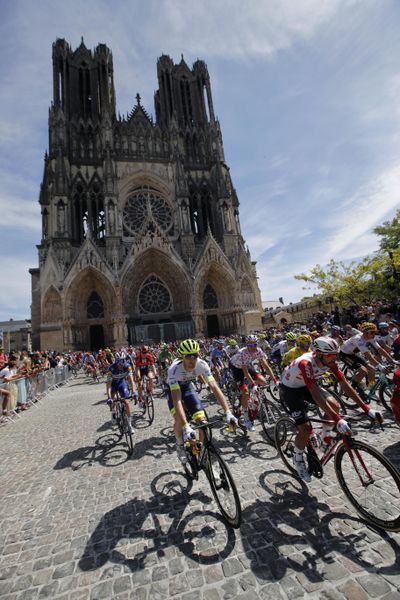 The pack rides by the Reims cathedral during the fourth stage of the Tour de France cycling race over 214 kilometers (133 miles) with start in Reims and finish in Nancy, France, Tuesday, July 9, 2019. (Christophe Ena / Associated Press)