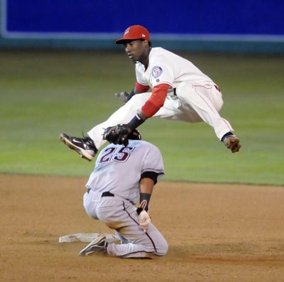 Indians Shortstop Jurickson Profar makes the tag and leaps to avoid Yakima's Henry Zabala late in the game.  (Jesse Tinsley)