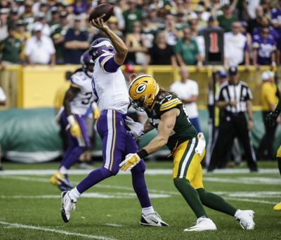 Roughing the passer penalties, like the one called on Green Bay’s Clay Matthews, right, for a hit on Minnesota’s Kirk Cousins, will harm the NFL, argues Norman Chad. (Mike Roemer / Associated Press)