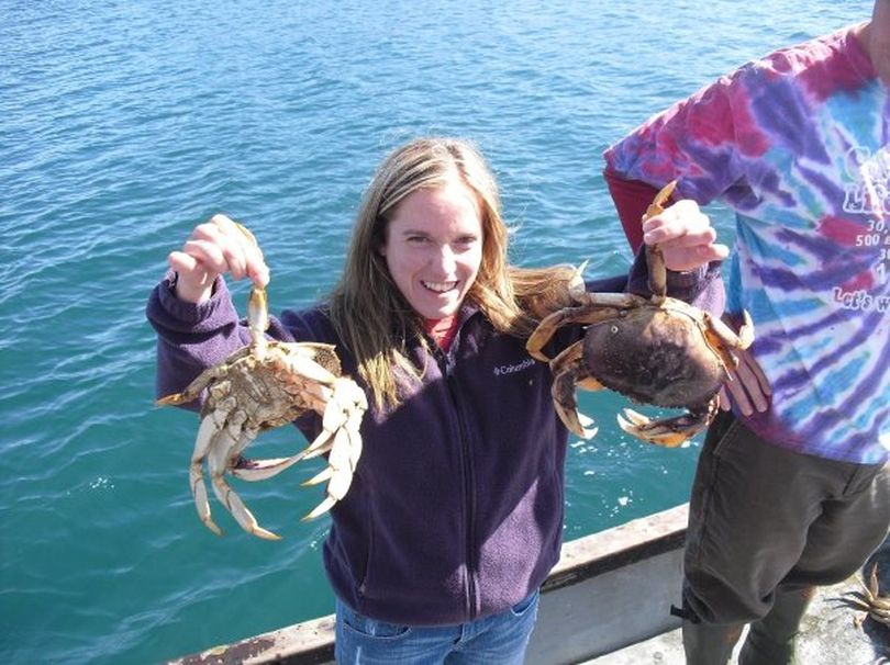 In this 2009 photo provided by the Lake and Peninsula Borough School District, Candice Berner, an Alaska special education teacher, holds up crab caught on a school district outing. Autopsy results announced Thursday, March 11, 2010, indicate Berner, 32, died March 8, 2010, in an animal attack outside the village of Chignik Lake, Alaska. Based on wolf tracks and other indications at the scene, Alaska State Troopers say Berner likely was killed by wolves but that the kind of animal cannot be determined without additional testing. (Lake And Peninsula School Distri)