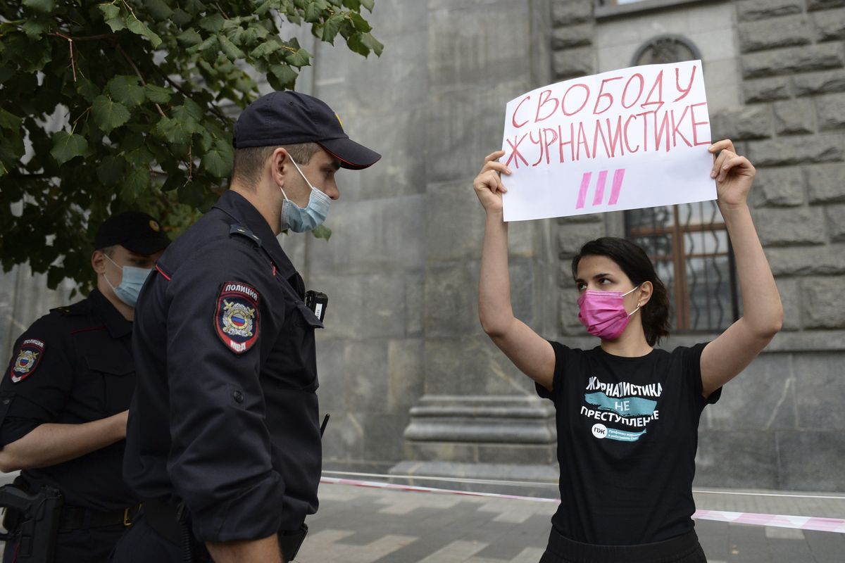 Police detain a journalist with the poster reads "Journalism Freedom", during individual pickets in Moscow, Russia, Saturday, Aug. 21, 2021. Russian police have detained several journalists who protested authorities