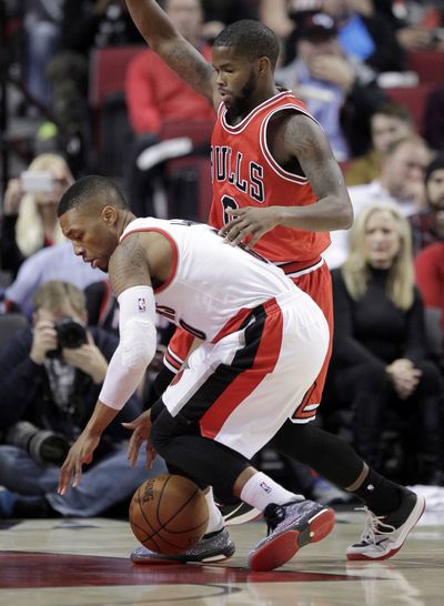 Portland’s Damian Lillard, left, had 21 points in win over Chicago. (Associated Press)