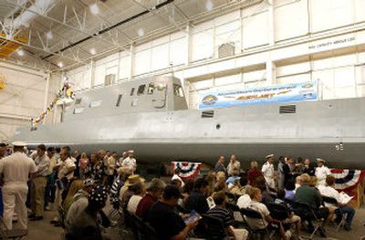 
A crowd of military personnel, contractor employees, civilian employees, media and general public wait in front of the new scale model destroyer for the christening of the ship in a building at the Bayview submarine research facility Wednesday. The ship will test technology for the Navy's new DDX destroyers. 
 (Photos by Jesse Tinsley/ / The Spokesman-Review)