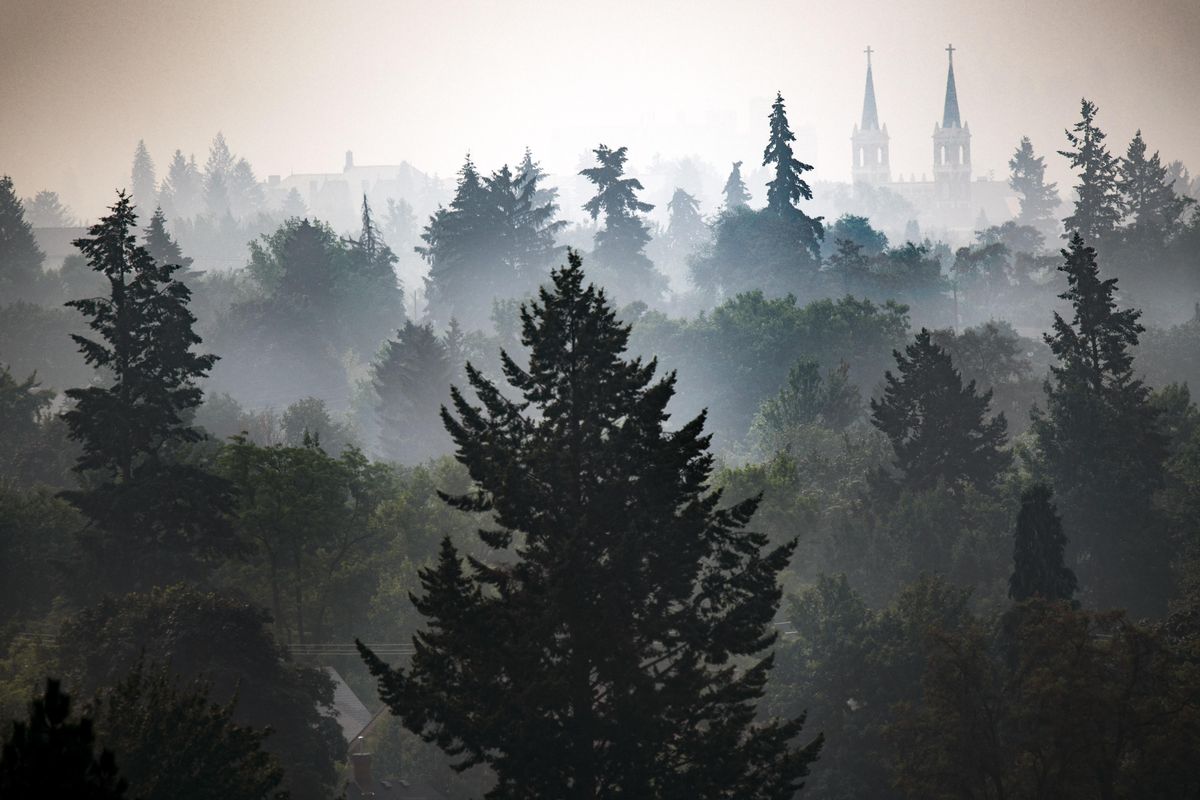 The spires of St. Aloysius Catholic Church are clouded in wildire smoke on Monday, Aug. 13, 2018. The smoke has created unhealthy breathing conditions across Northeastern Washington and North Idaho. (Colin Mulvany / The Spokesman-Review)
