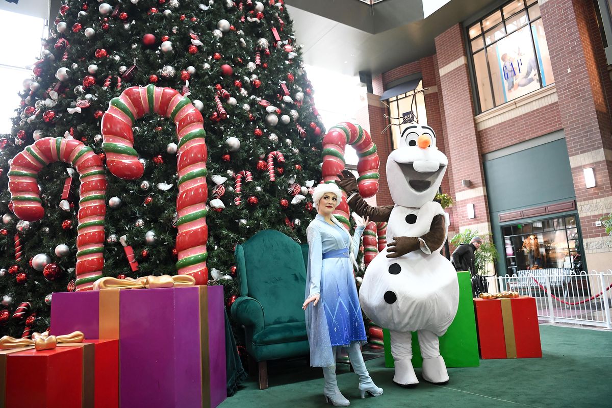 Elsa and Olaf the snowman explore River Park Square before the premiere of "Frozen II" on Friday at River Park Square. (Tyler Tjomsland / The Spokesman-Review)