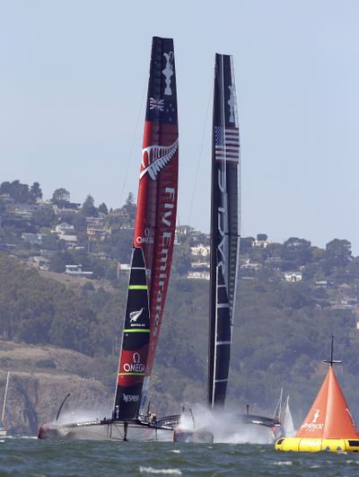 Emirates Team New Zealand, left, and Oracle Team USA, right, come off the start line and head for the first mark on Wednesday. (Associated Press)