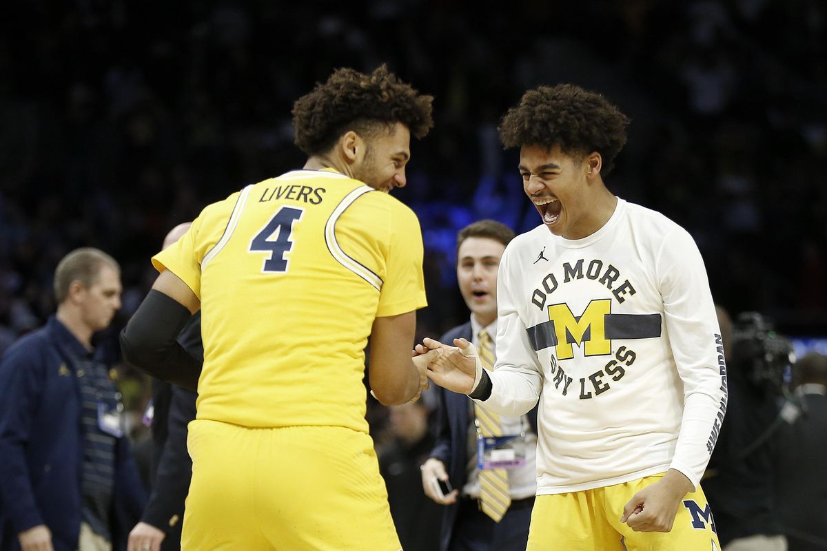 Michigan forward Isaiah Livers (4) celebrates with teammates after Michigan defeated Florida State in an NCAA men