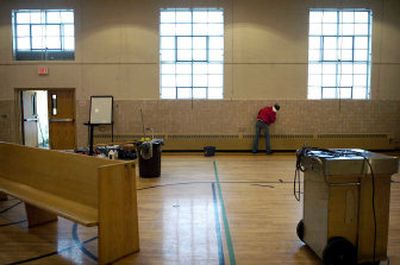 
Brianne Reeves of Capstone Construction cleans the walls of the gymnasium at Salem Lutheran Church recently. The church will temporarily hold services, meetings and programs in the gymnasium, which had only minimal smoke damage from a recent fire. Also, several churches have offered space.
 (Holly Pickett photos/ / The Spokesman-Review)