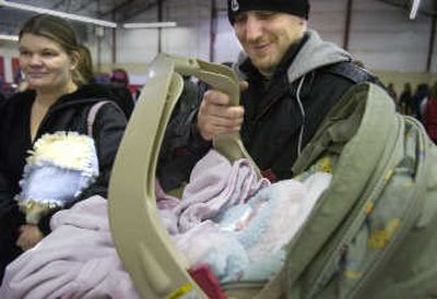 
Jessica and Richard Hawks Jr. stand in line Wednesday at the Christmas Bureau with newborn Kastile Amber. 
 (CHRISTOPHER ANDERSON / The Spokesman-Review)