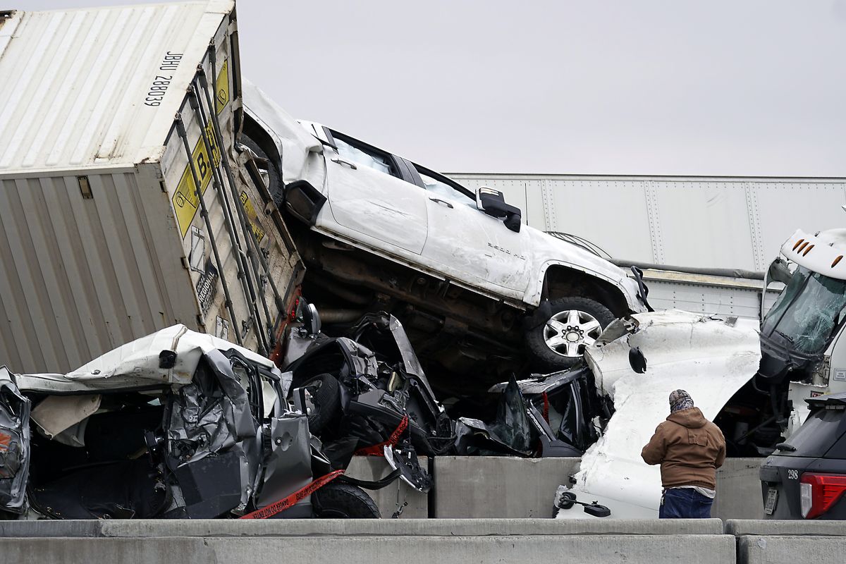 Vehicles are piled up after a fatal crash on Interstate 35 near Fort Worth, Texas on Thursday, Feb. 11, 2021. The massive crash involving 75 to 100 vehicles on an icy Texas interstate killed some and injured others, police said, as a winter storm dropped freezing rain, sleet and snow on parts of the U.S.  (Lawrence Jenkins)