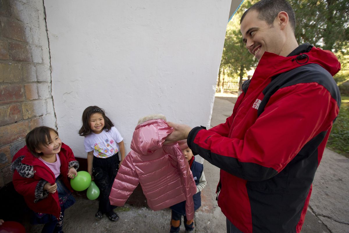1st Lt. Mike Capelle with Fairchild’s 92nd Air Refueling Wing helps hand out winter coats to preschoolers in Vasilievka, Kyrgyzstan. 