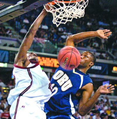 
WSU's Kyle Weaver flushes down a dunk over the defense of Oral Roberts' Marchello Vealy.
 (Christopher Anderson / The Spokesman-Review)