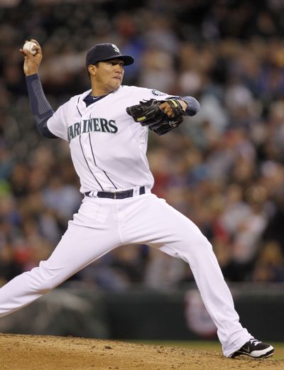 Starting pitcher Hector Noesi pitched eight scoreless innings to pick up his first victory as a Mariner. (Associated Press)