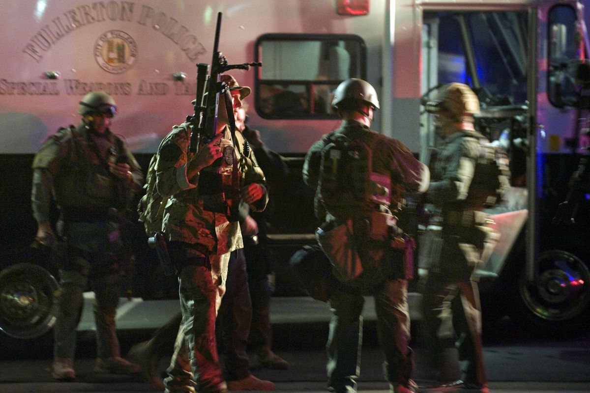 SWAT team members form up near a command post south of the Cal State Fullerton campus, Wednesday, Dec. 12, 2012, in Fullerton, Calif. Students were placed on lock down as police searched for two suspects in a jewelry store robbery, who were considered armed and dangerous. (Bruce Chambers / Orange County Register)