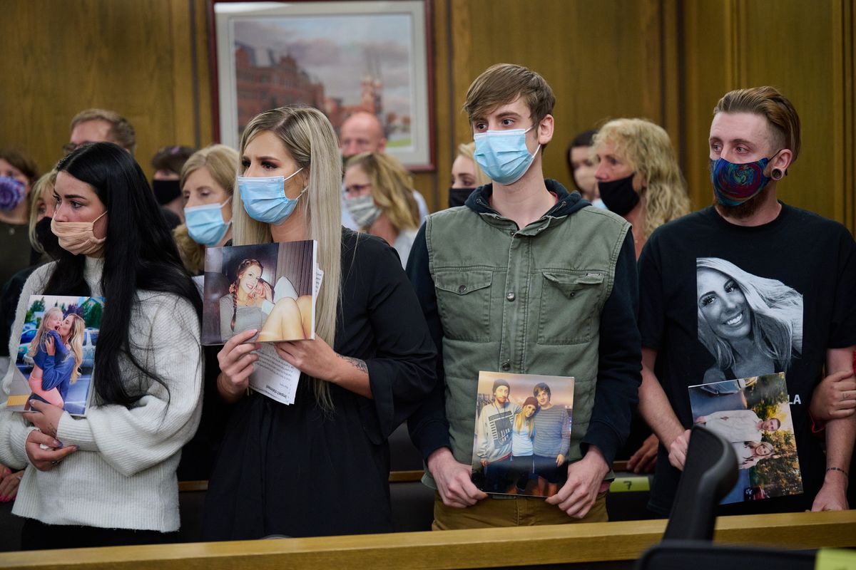 Left to right, Hannah Ayers, friend to Makayla Young. Siblings Emily, Connor and Andrew hold family photos of Makayla during the sentencing of Anthony Fuerte, Monday, May 24, 2021. Fuerte, who pled guilty to first-degree murder in Makayla’s death, was sentenced to 30-years in prison by Superior Court Judge Maryann Moreno, Monday, May 24, 2021.  (COLIN MULVANY/THE SPOKESMAN-REVIEW)