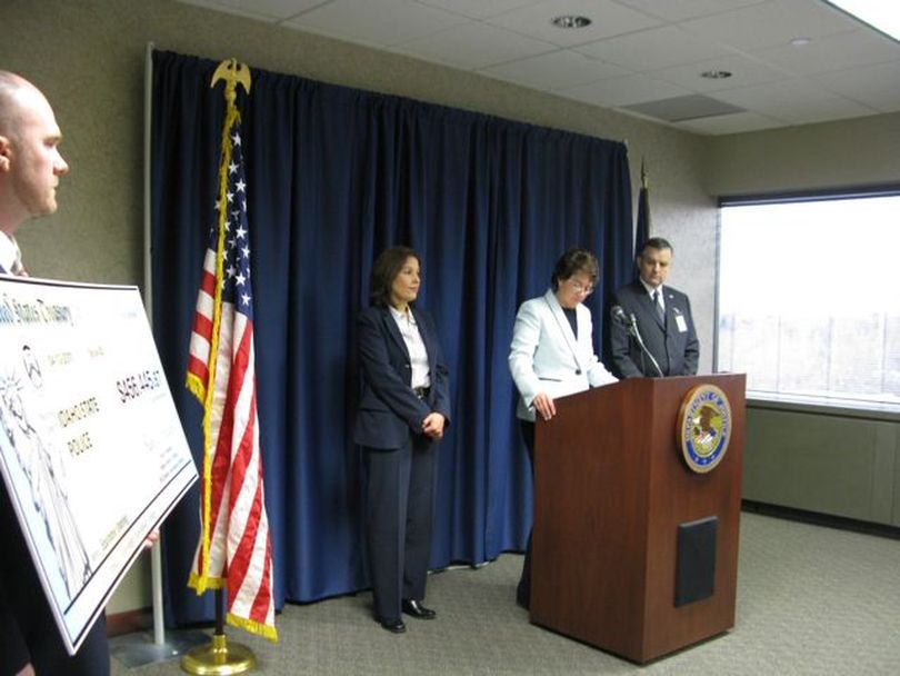 U.S. Attorney for Idaho Wendy Olson speaks at a news conference in Boise on Wednesday to present proceeds from a Coeur d'Alene drug trafficker's seized assets to the Idaho State Police and Coeur d'Alene Police Department. To the right of Olson is Col. Jerry Russell, ISP director; to the left is IRS Assistant Special Agent in Charge Lilia Ruiz. (Betsy Russell)