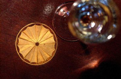 
A crystal wine glass sits on an antique inlaid table.
 (BRIAN PLONKA / The Spokesman-review / The Spokesman-Review)
