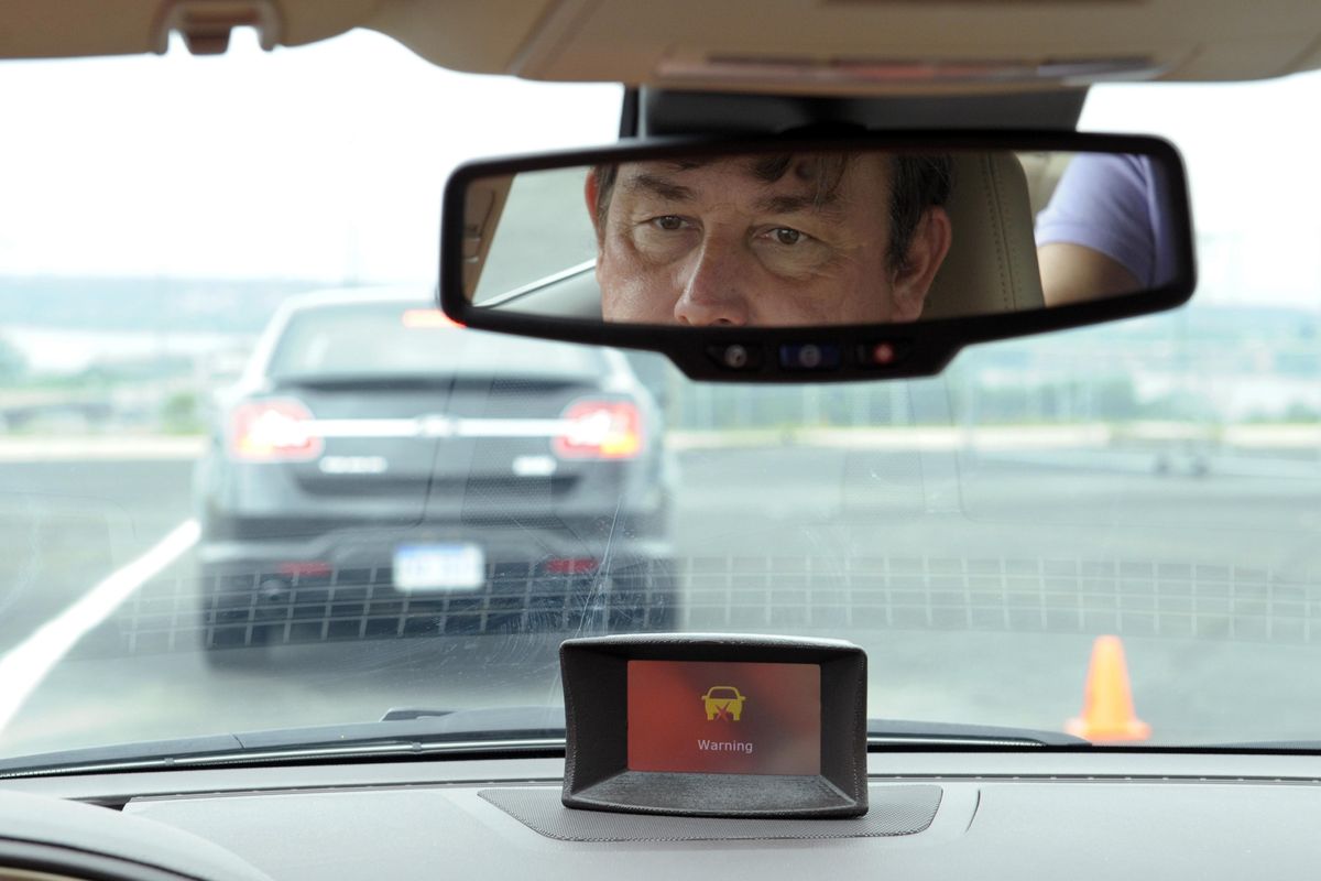 In this May 22, 2012, file photo, professional test driver Dave McMillan demonstrates the dashboard warning signal at an automobile test area in Oxon Hill. (Susan Walsh / Associated Press)