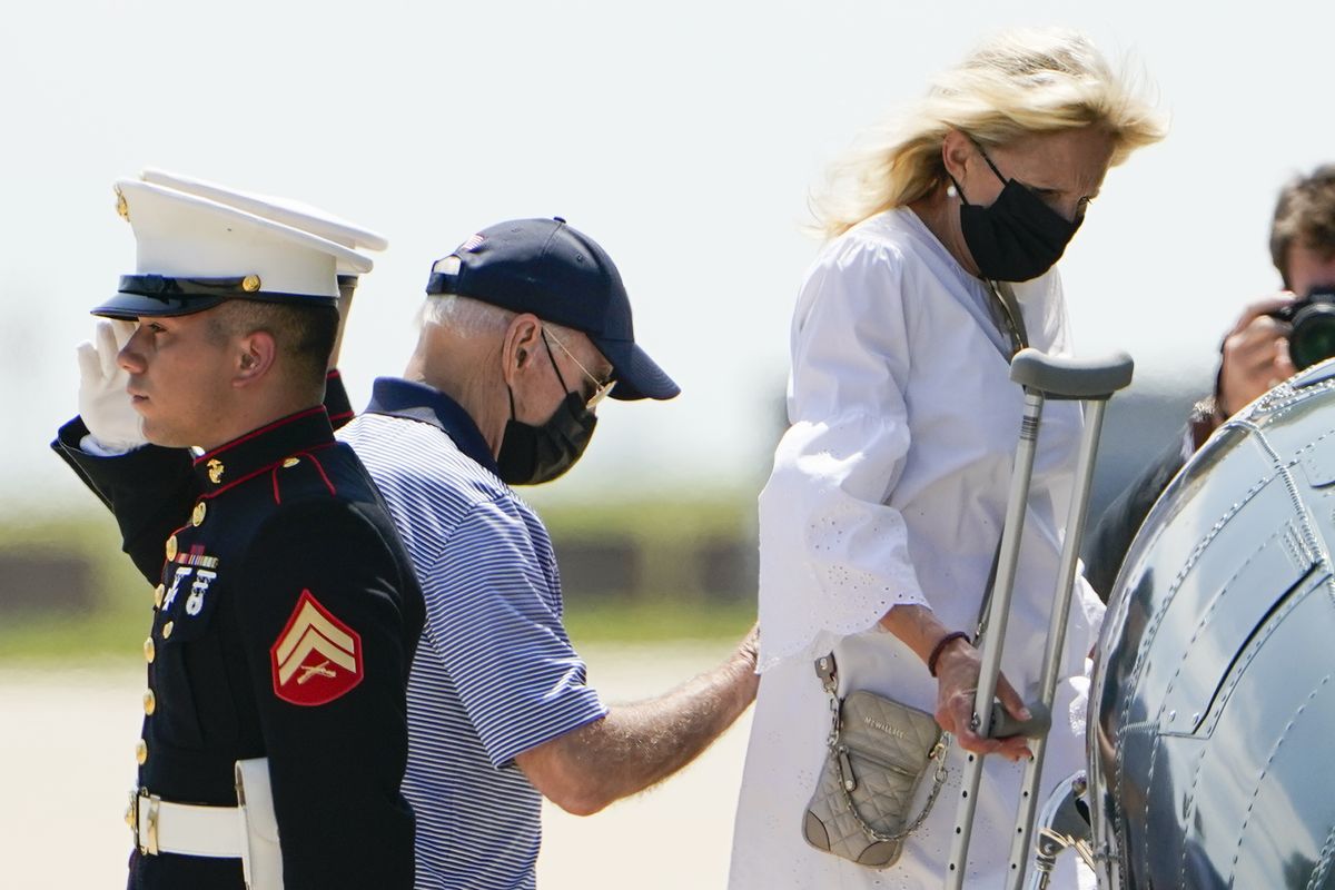 President Joe Biden helps first lady Jill Biden as they board Marine One to depart Delaware Air National Guard Base in New Castle, Del., Friday, Aug. 13, 2021.  (Manuel Balce Ceneta)