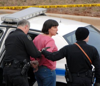 A  woman is taken into custody by Huntsville, Ala., police Friday, in connection with  shootings  at the University of Alabama in Huntsville.  (Associated Press)