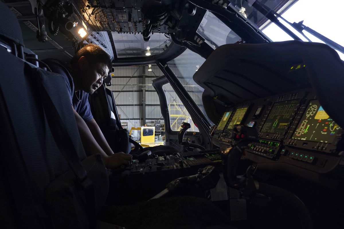 Avionics mechanic Mike Luong inspects the control panel of Sikorsky Firehawk helicopter at the California Department of Forestry and Fire Protection’s Sacramento Aviation Management Unit based at McClellan Airpark in Sacramento, Calif., on Friday.  (Associated Press)