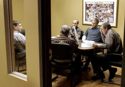 
Former Star Tribune of Minneapolis Publisher Joel Kramer, shown left through the window, holds a staff meeting at the offices of MinnPost, a new daily news Web site featuring local news coverage. At right is Managing Editor Roger Buoen. Associated Press
 (Associated Press / The Spokesman-Review)