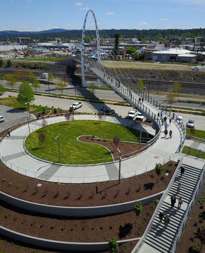 Visitors and dignitaries walk across the University District Gateway Bridge after a ceremonial ribbon-cutting in this May 2019 photo. Candidates for Spokane City Council in the northeast district say the project, while impressive, could have been better managed by the city for less money. (Jesse Tinsley / The Spokesman-Review)