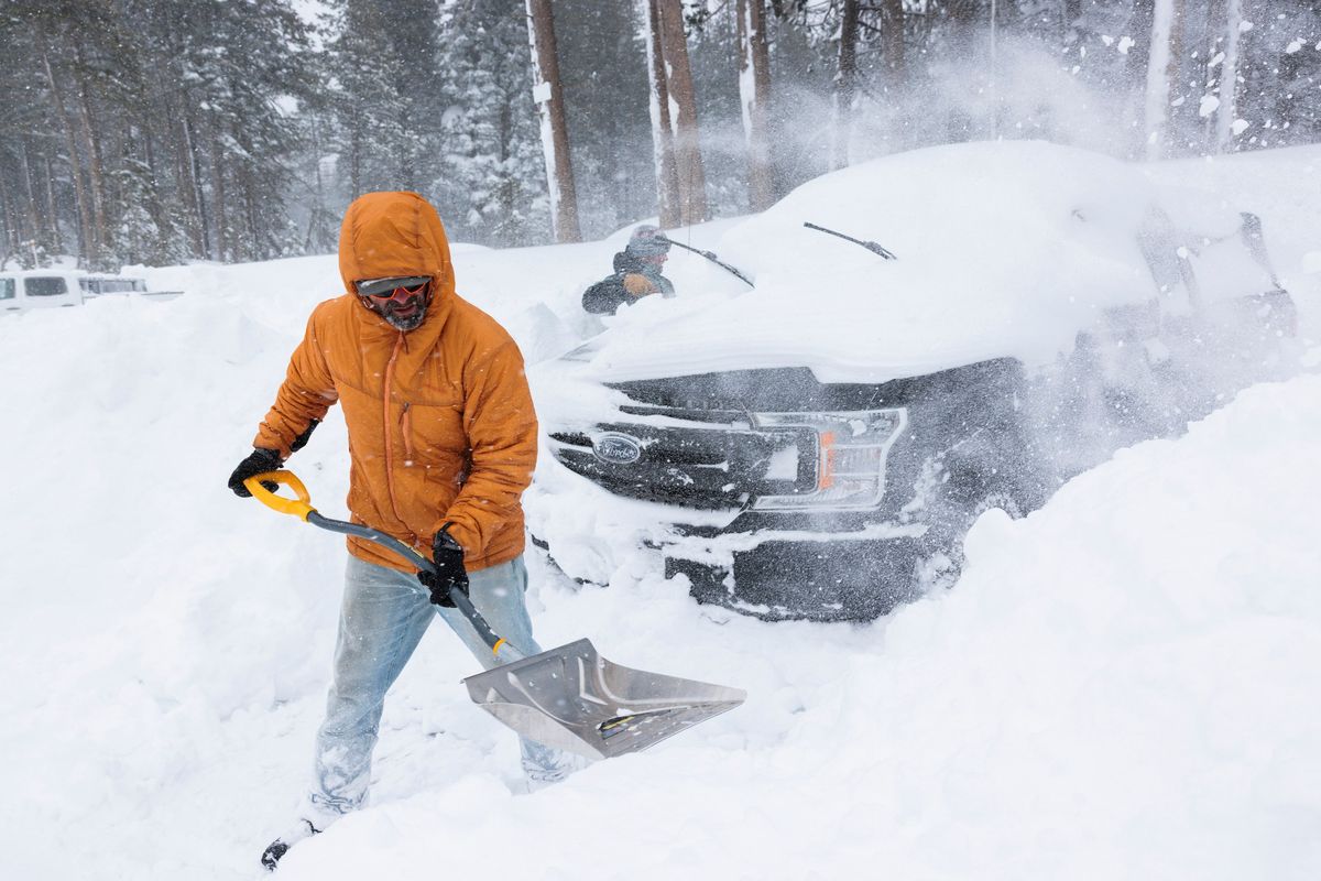 Locals dig out a friend’s truck on Wednesday at the Castle Peak trailhead near Soda Springs, Calif. The bodies of eight backcountry skiers killed during an avalanche were found during a rescue effort late Tuesday near Castle Peak.  (MAX WHITTAKER)