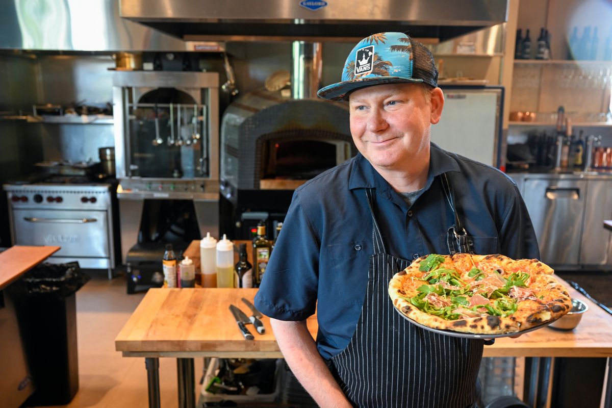 Chef Ian Wingate, who spent many years as head chef at the Davenport Hotel group as well as running his own Moxie restaurant, holds a prosciutto pizza Wednesday at his newly-opened Outsiders, a casual bar and restaurant in the Papillon Building, 908 N. Howard St., near the Spokane Arena and the Flour Mill.  (Jesse Tinsley/The Spokesman-Review)