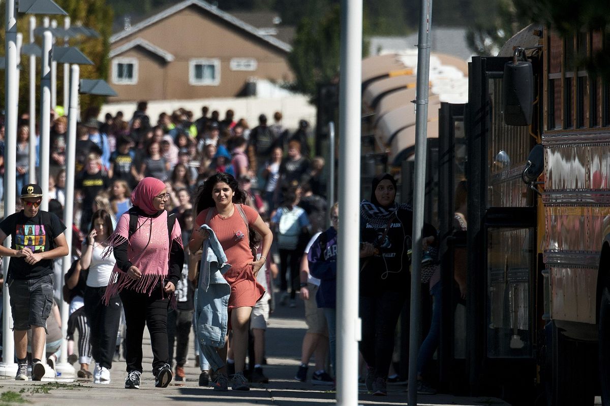 Students walk to the buses at Central Valley High School on Monday, Sept. 11, 2017. (Kathy Plonka/The Spokesman-Review)