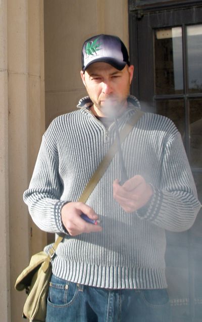 ORG XMIT: MTMG101  Jason Christ smokes a bowl of marijuana in front of the civic center, around the corner from the police station, in downtown Great Falls, Mont., Friday Oct. 23, 2009. Christ holds clinics to help people get their state-issued medical marijuana cards in Montana. More than 250 registered for the Great Falls class, which features a doctor on site able to certify the applicant's medical condition. (AP Photo/Matt Gouras) (Matt Gouras / The Spokesman-Review)