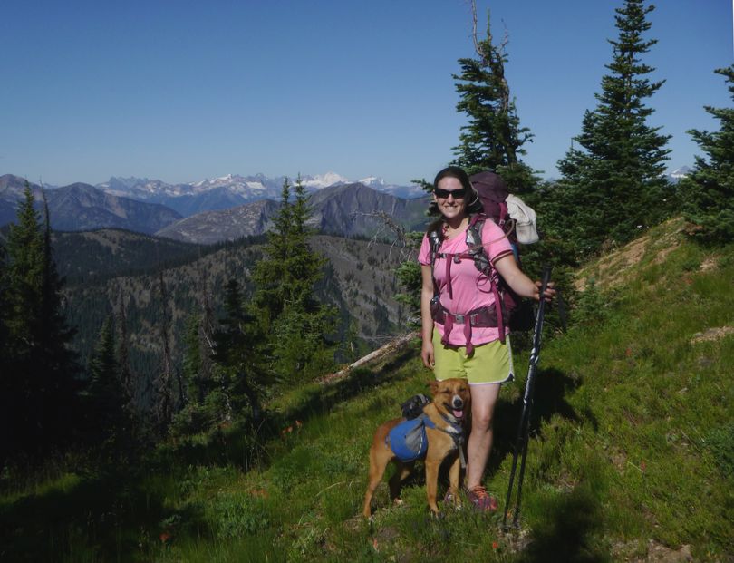 Samantha Journot pauses with her dog, Duke, on the Pacific Crest Trail -- Mount Baker's white summit showing in the background -- during a 100-mile backpacking trek through the Pasayten Wilderness. (Rich Landers)