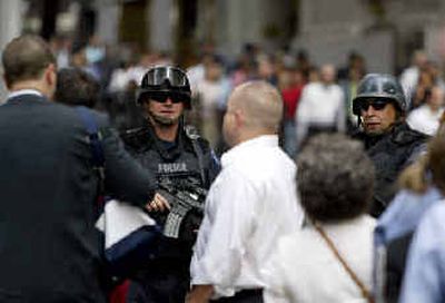 
Two armed police officers stand guard Monday on Wall Street. 
 (Associated Press / The Spokesman-Review)