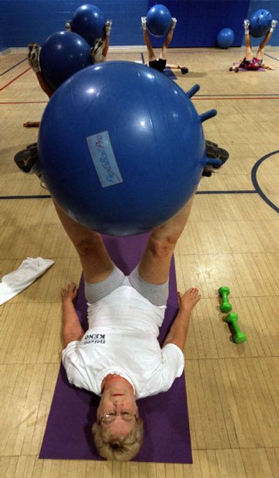 
Betty Kovacich does leg lifts in an exercise class using a fitness ball at a YMCA in Livonia, Mich.
 (Knight Ridder Tribune / The Spokesman-Review)