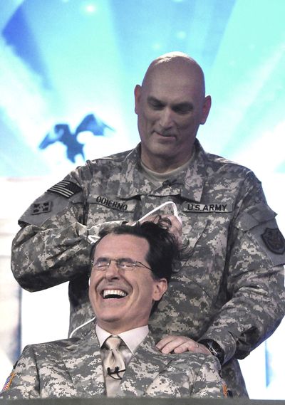 ORG XMIT: BAG101 In this handout photo taken Sunday, June 7, 2009, released by the U.S. military, comedian Stephen Colbert, from the Comedy Central television program gets a military style haircut from General Raymond Odierno, Commander of the Multinational Corps, Iraq, during the taping the first of four shows at Camp Victory in Baghdad, Iraq, Sunday, June 7, 2009. (AP Photo/ Steve Manuel, HO) (The Spokesman-Review)