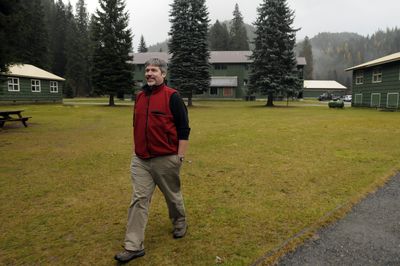 Bob Baker, executive director of Lutherhaven Ministries, walks around the Shoshone Base Camp, a former Forest Service work camp along the Coeur d’Alene River.   (Jesse Tinsley / The Spokesman-Review)