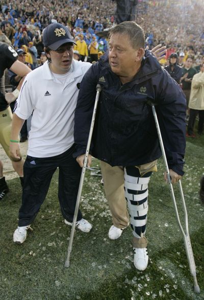 Irish coach Charlie Weis and his son, Charlie Weis Jr., enjoy a painful win.  (Associated Press / The Spokesman-Review)