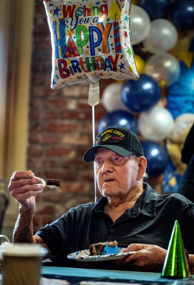 Howard Rieckers, a U.S. Marine veteran from World War II, enjoys a piece of birthday cake during his birthday party held Monday at The Gardens On University, in the Spokane Valley. He turned 101 on Sunday.  (COLIN MULVANY/THE SPOKESMAN-REVI)