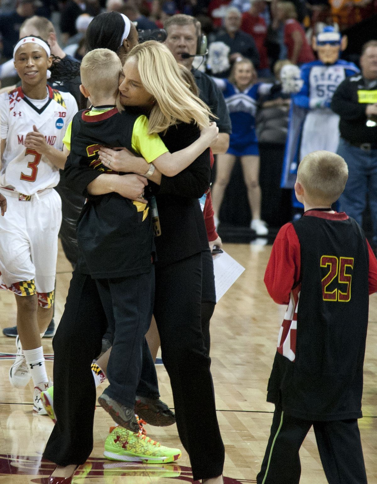 Maryland head coach Brenda Frese sweeps up her son Tyler Thomas after defeating Duke. (Dan Pelle)