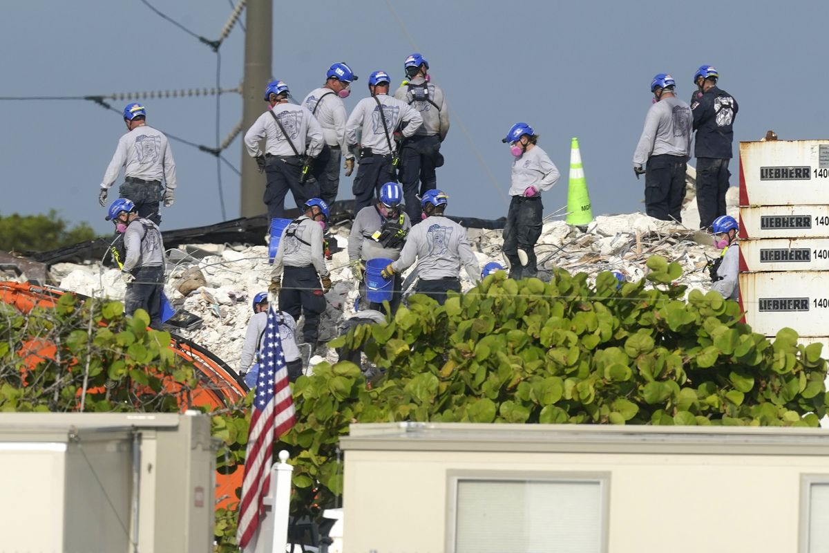 Rescue crews work at the site of the collapsed Champlain Towers South condo building after the remaining structure was demolished Sunday, in Surfside, Fla., Monday, July 5, 2021. Many people are unaccounted for in the rubble of the building which partially collapsed June 24.  (Lynne Sladky)