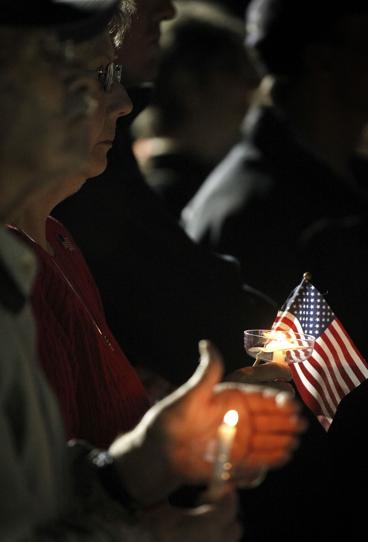 People gather in Centennial Plaza in Midland, Texas on Saturday, Nov. 17, 2012 for a candlelight vigil held in honor of four veterans who were killed when a freight train hit a parade float Thursday. (James Durbin / Midland Reporter-telegram)
