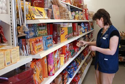 Yelena Ustimenko straightens the shelves in the Kiev Market on Sprague Avenue just west of Conklin Road. The store offers shoppers items that would otherwise be impossible to find in America.
 (Liz Kishimoto / The Spokesman-Review)