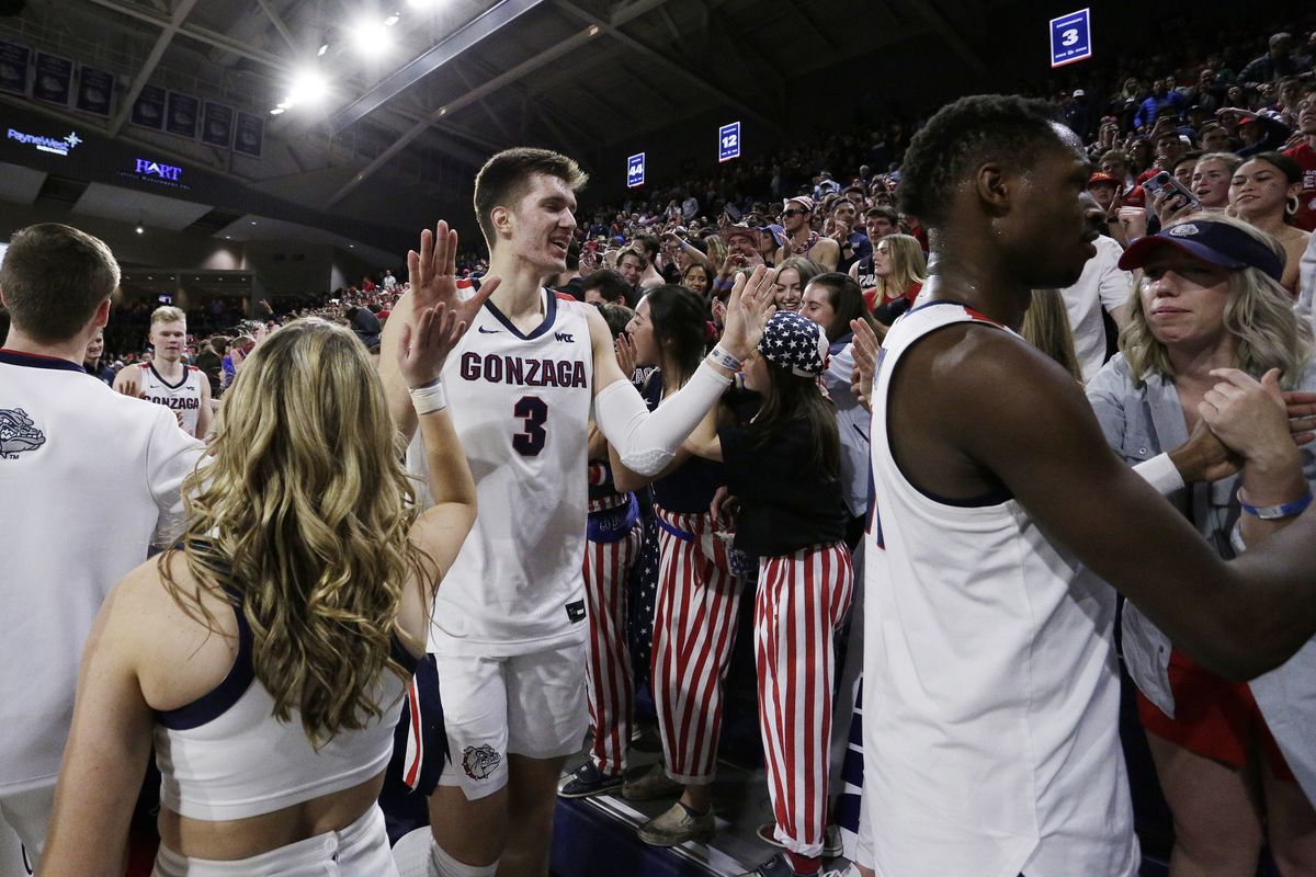 Gonzaga forward Filip Petrusev, last season’s West Coast Conference Player of the Year, greets cheerleaders and Bulldogs fans after a game against visiting Saint Mary’s on Feb. 29.  (Associated Press)
