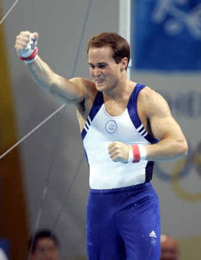 
American gymnast Paul Hamm reacts after sticking his landing on the high bar during the men's individual all-around final on Wednesday. 
 (Associated Press / The Spokesman-Review)