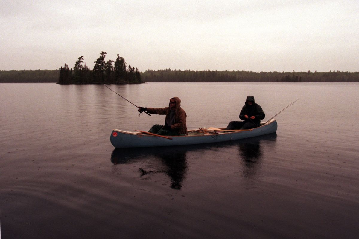 On a rainy springtime day, Dennis Anderson, in the stern, and Terry Arnesen fish for their dinner in the Boundary Waters.  (MARLIN LEVISON/Minnesota Star Tribune)