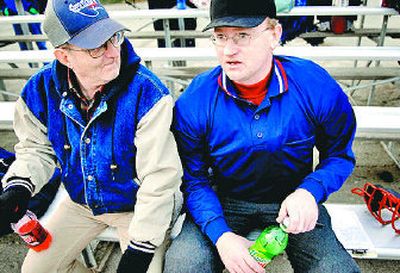 
Matthew Lane takes a break between innings with his father, Walter.  