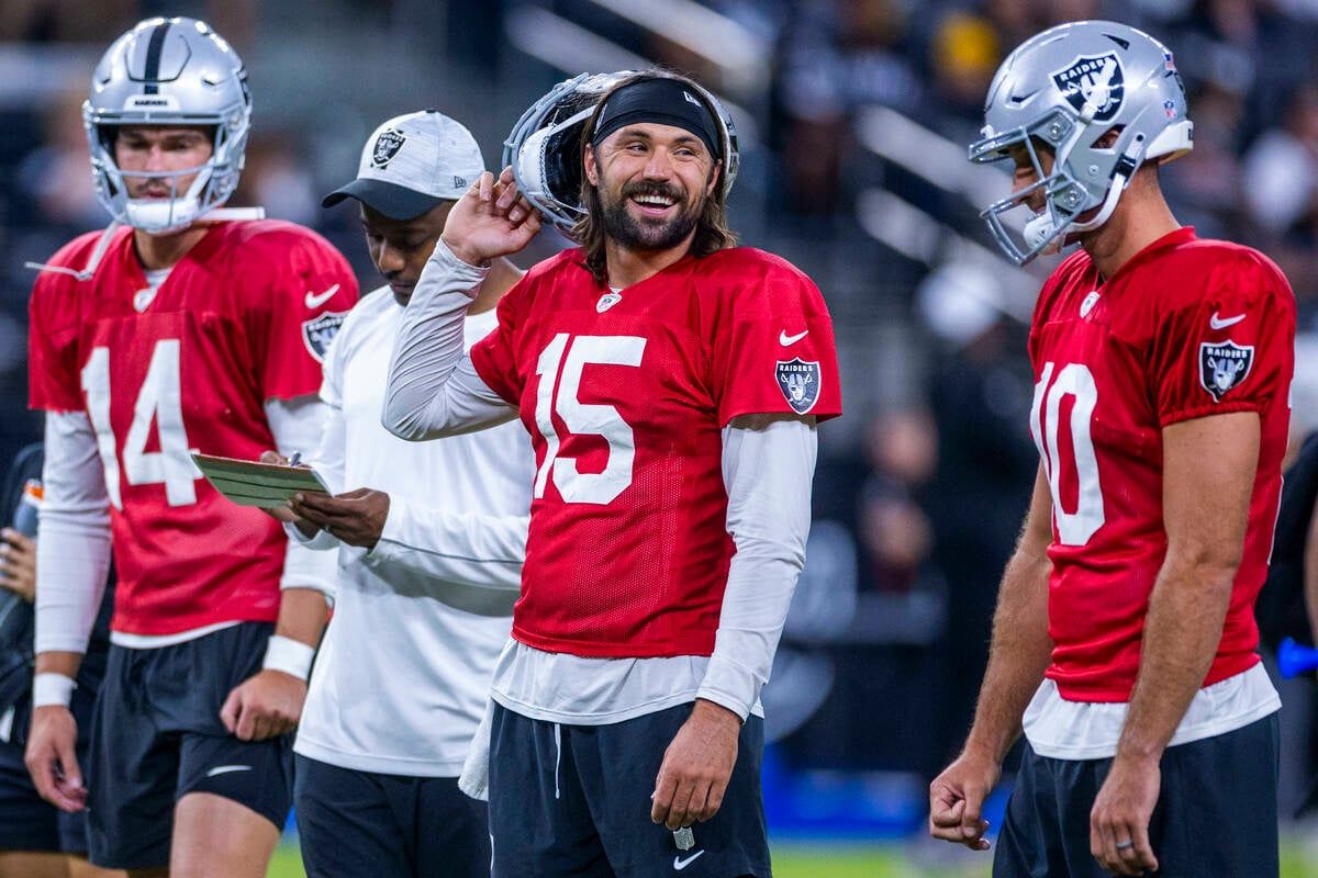 Raiders quarterback Gardner Minshew (15) laughs with quarterback Nathan Peterman (10) during an open practice at Allegiant Stadium on Tuesday, Aug. 20, 2024, in Las Vegas.   (Tribune News Service)