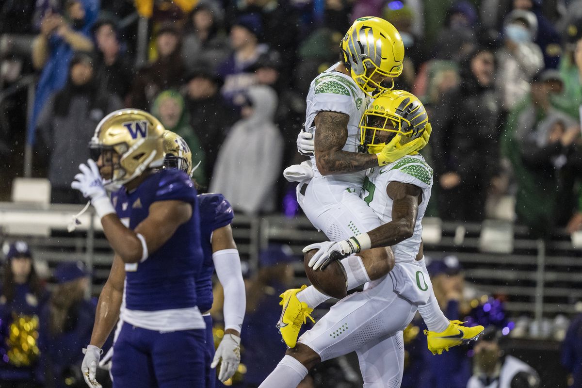 Oregon wide receiver Mycah Pittman, left, and wide receiver Devon Williams, right, celebrate a touchdown reception by Williams during the first half of a NCAA college football game against Washington, Saturday, Nov. 6, 2021, in Seattle.  (Associated Press)