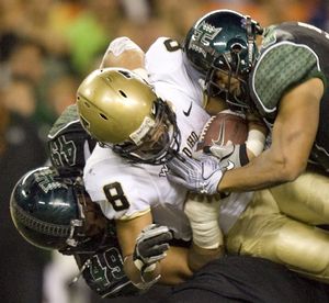 Hawaii defensive tackle Kaniela Tuipulotu (49) and Hawaii safety Mana Silva (43) tackle Idaho running back Kama Bailey (8) in the second quarter during an NCAA college football game  Saturday, Oct. 30, 2010 in Honolulu. (Eugene Tanner / Fr168001 Ap)