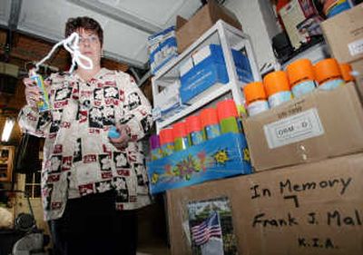 
Spraying Silly String from a can, Marcelle Shriver stands next to  cans stored in the garage of her Stratford, N.J., home. American troops use the substance to detect trip wires around bombs. Associated Press
 (Associated Press / The Spokesman-Review)